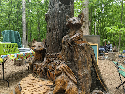 carving in tree stump of creatures in annandale va